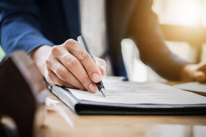 man signing real estate
